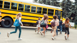 Kids run to board school bus