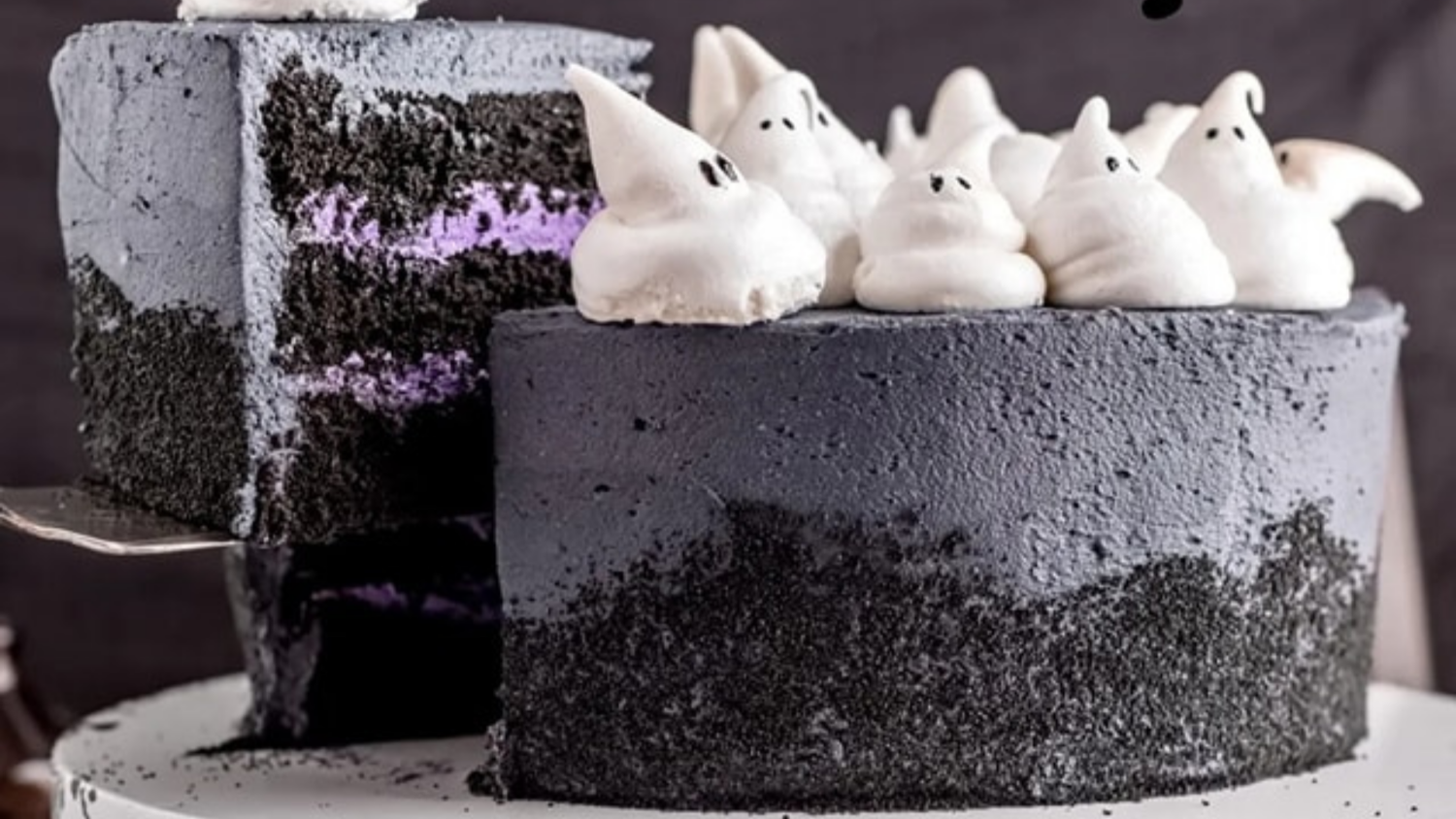 Black Halloween cake with cute meringue ghosts on top