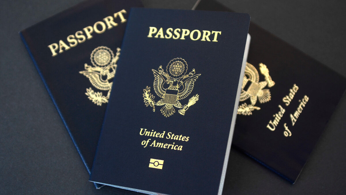 three U.S. passports on black background