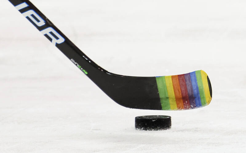 Rangers player Zac Jones skates with Pride Tape on hockey stick