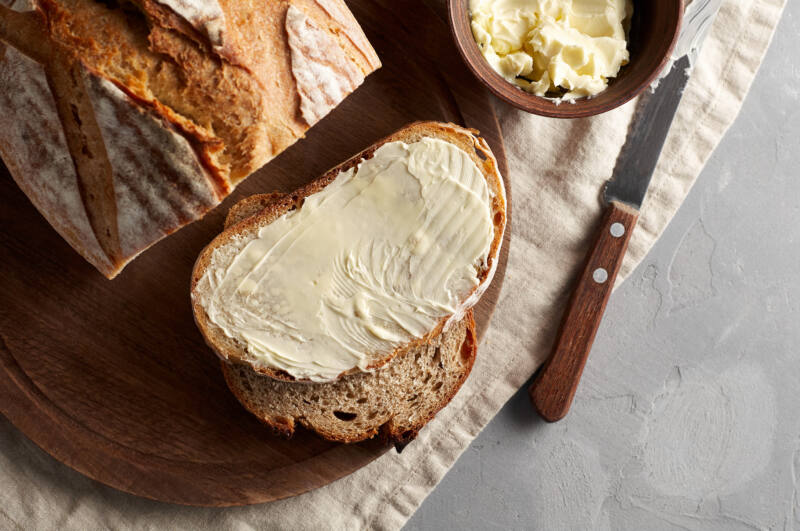 Butter spread on artisan sliced bread