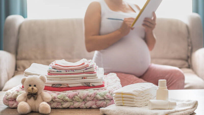 Pregnant woman checks items of to-do list ahead of baby's birth