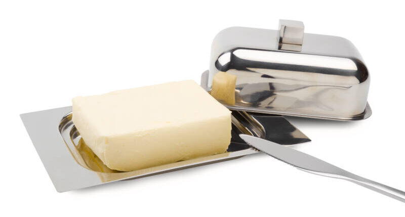 Butter on silver butter dish with knife