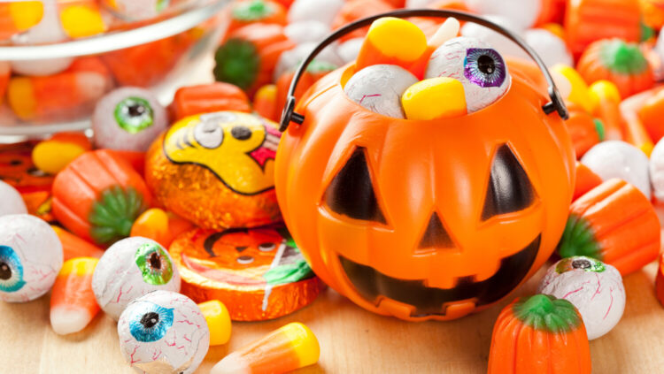 Jack-o'-lantern overflowing with Halloween candy