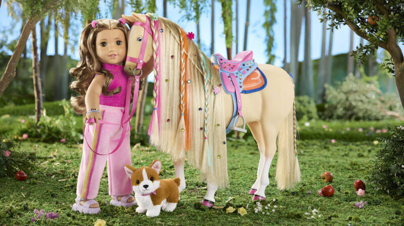 American Girl doll Lila stands with her horse and dog