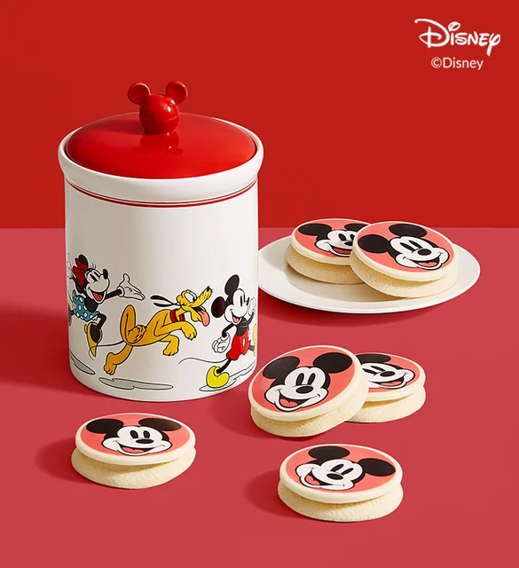 mickey mouse themed cookie jar surrounded by mickey mouse cookies