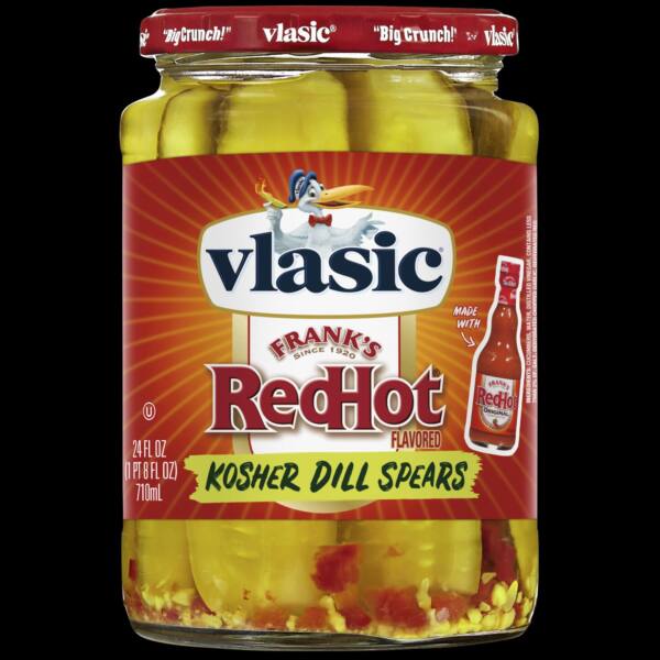jar of vlasic kosher dill pickles with frank's red hot sauce on black background