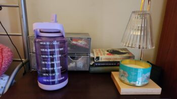 purple water bottle sitting on desk