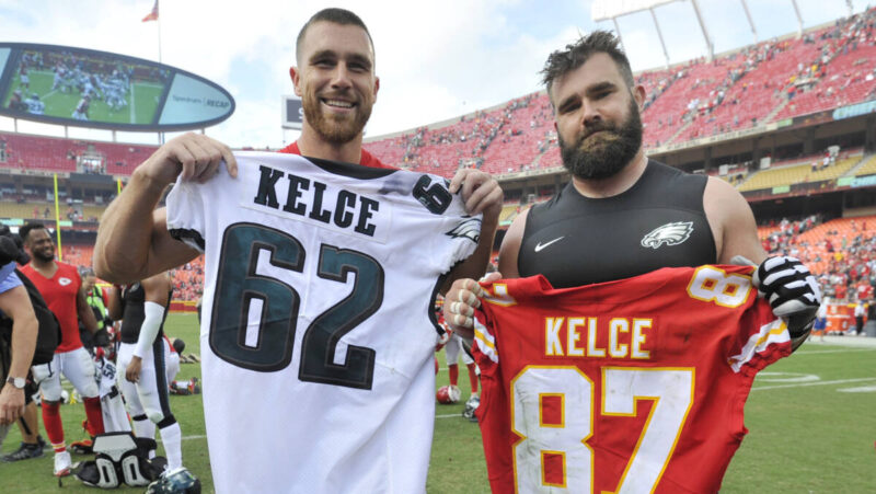 Travis Kelce, left, and brother Jason Kelce hold the other's jersey
