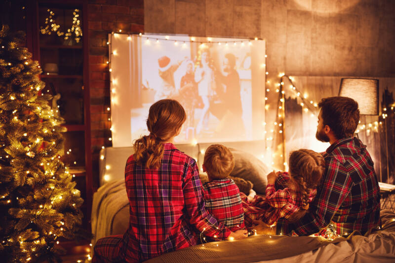 Family watches old Christmas movies on projector
