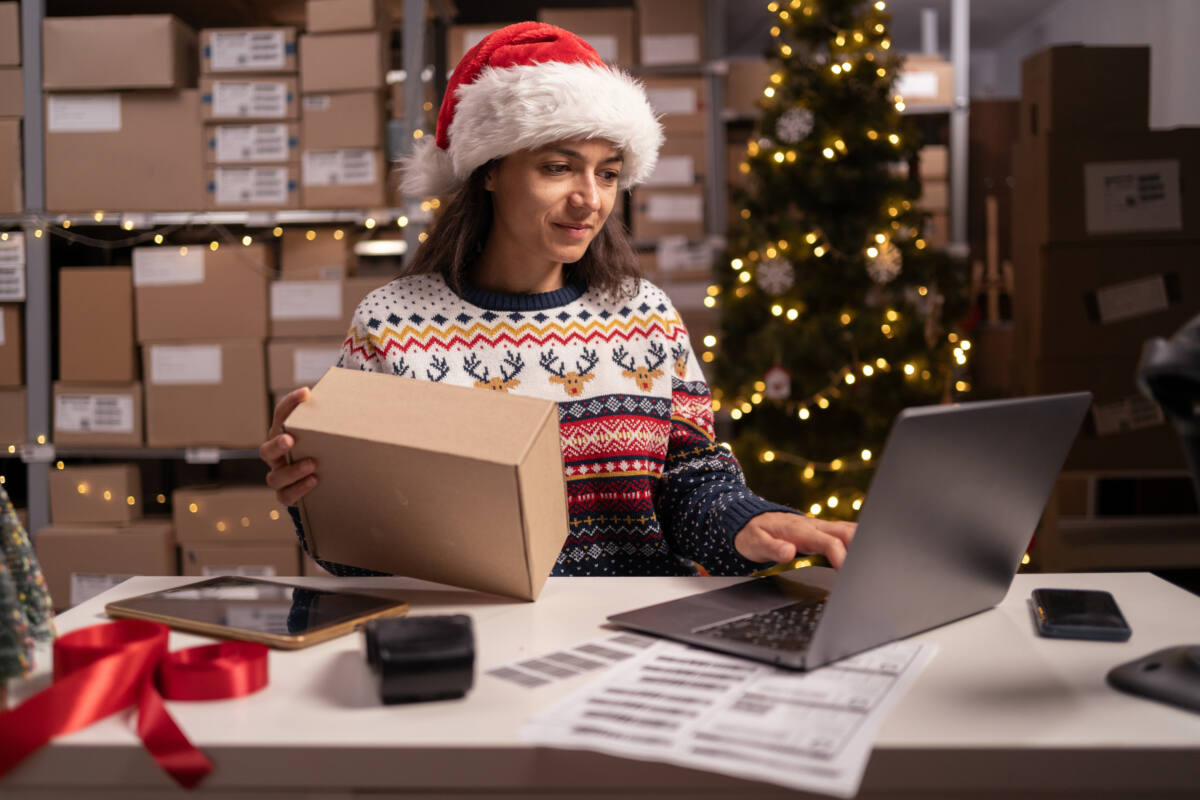 Employee prepares package to ship for Christmas holidays