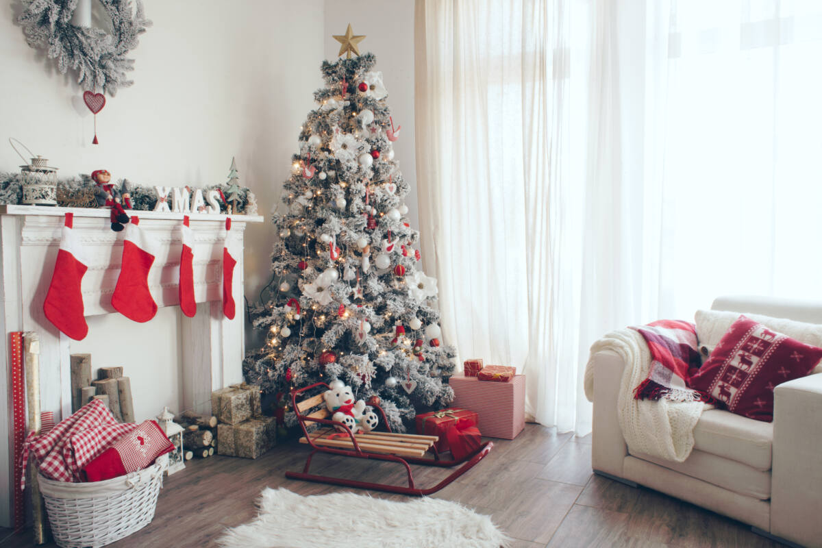 living room decorated with Christmas trees and stockings