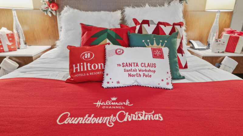 Hilton hotel bed made up with holiday-themed bedding