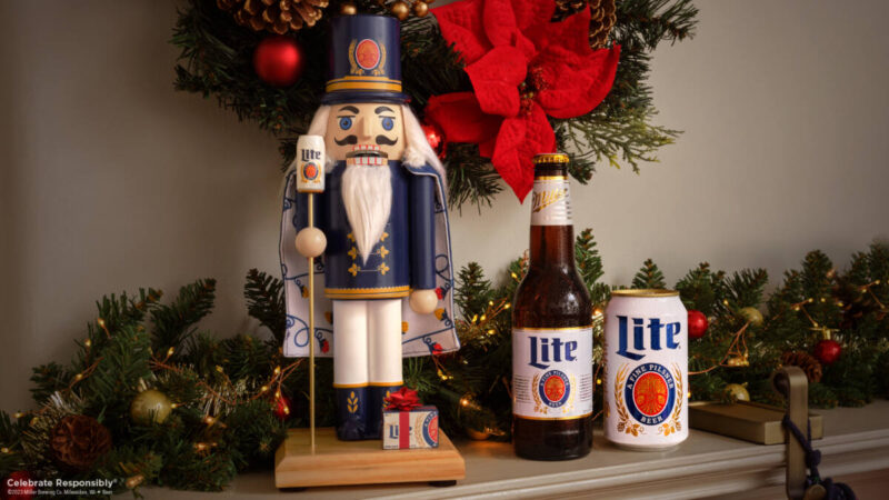 Miller Lite BeerCracker, nutcracker that opens beer bottles and cans, next to beer and poinsettia wreath