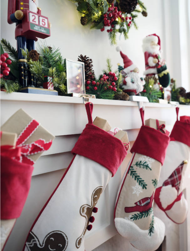 A living is decorated in traditional red and green holiday decor