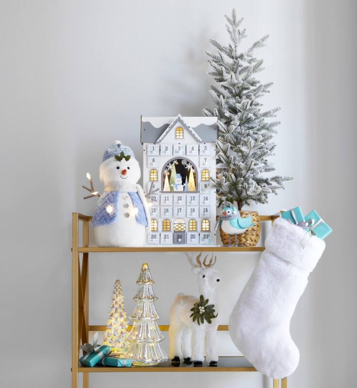 A room features snow-themed decor with light blue and golden accent pieces.