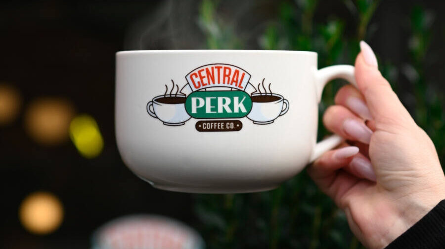 Hand holds Central Perk coffee cup