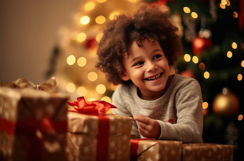 Cute child opens Christmas gifts