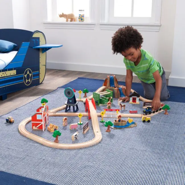 child playing with Kidcraft Farm Train Set