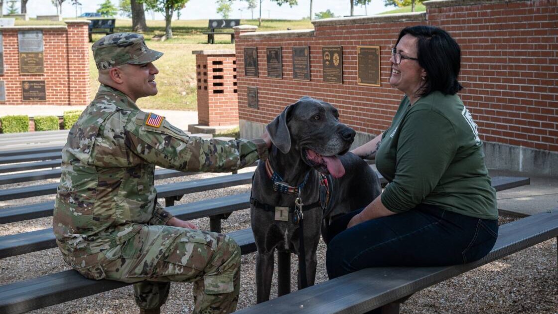 Maverick the dog with his handler and US service member