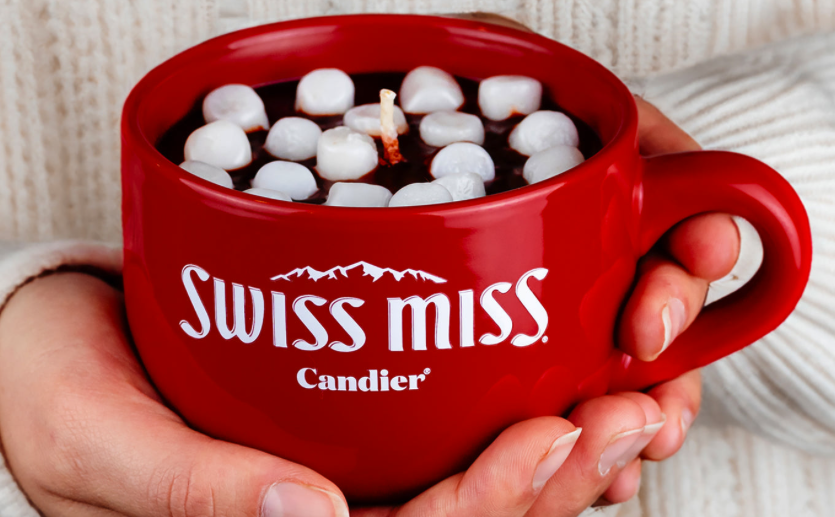 Hands hold Swiss Miss candle