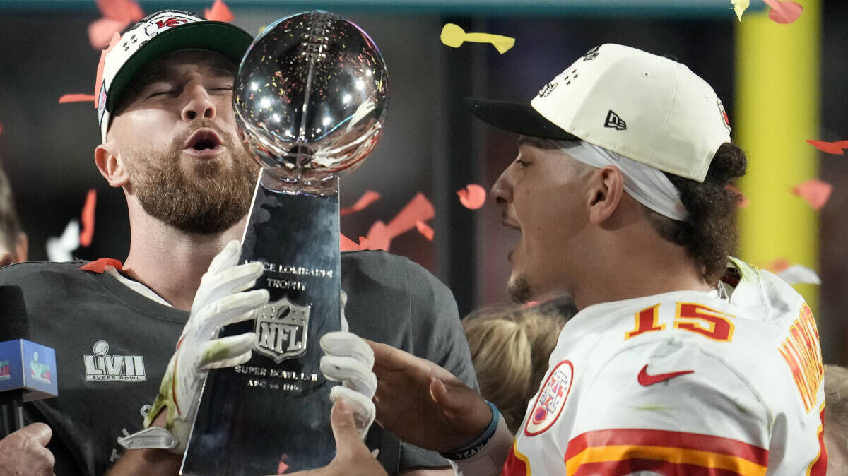 Travis Kelce and Patrick Mahomes hold the Vince Lombardi Trophy at Super Bowl