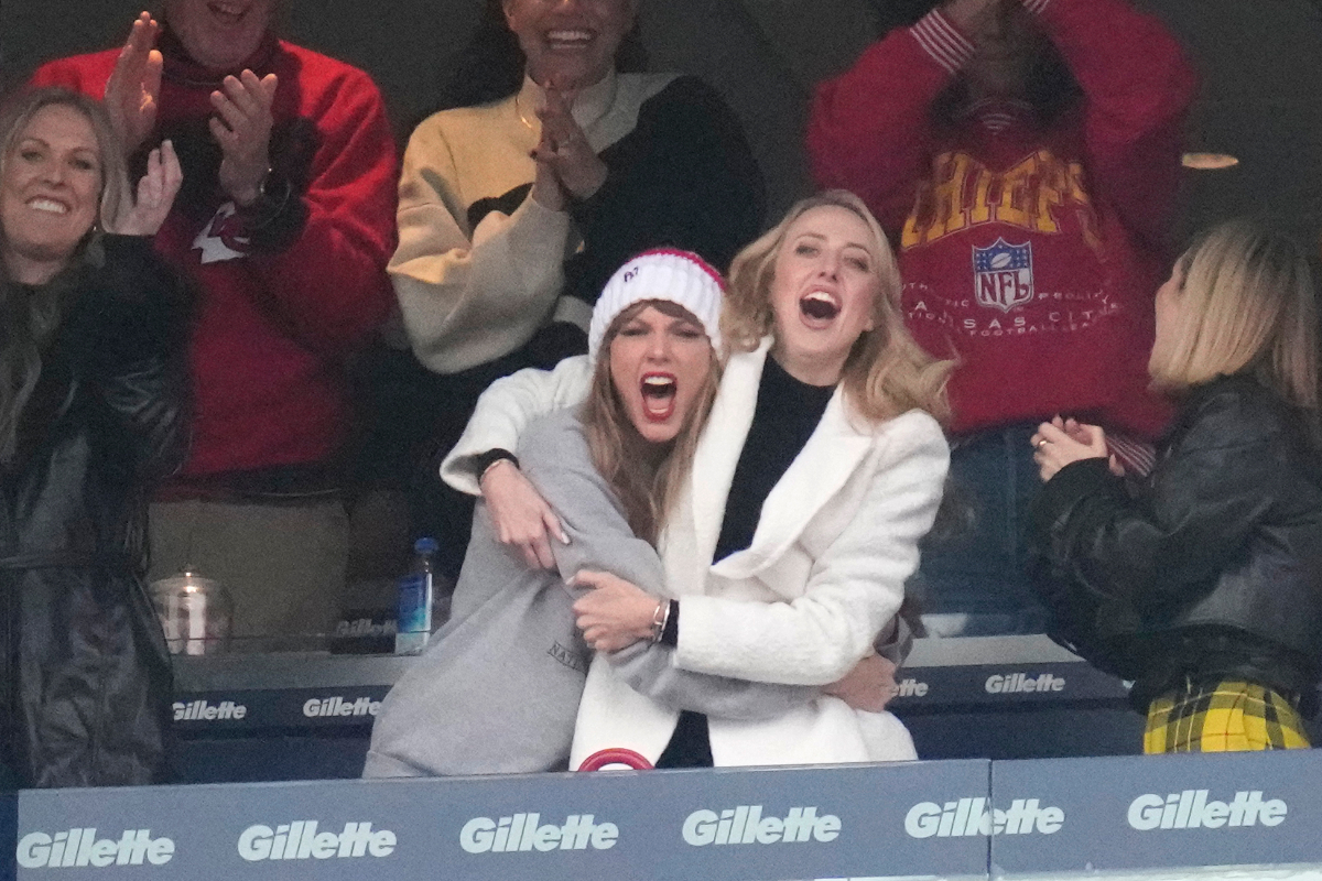Taylor Swift and Brittany Mahomes embrace at a Kansas City Chiefs game