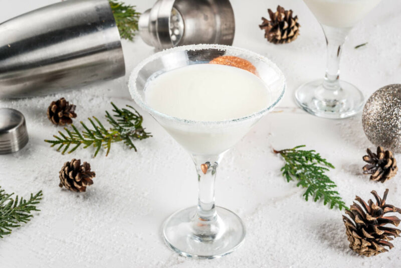 Ideas and recipes for Christmas drink. White Chocolate Snowflake Martini cocktail, on white marble table with Christmas decoration