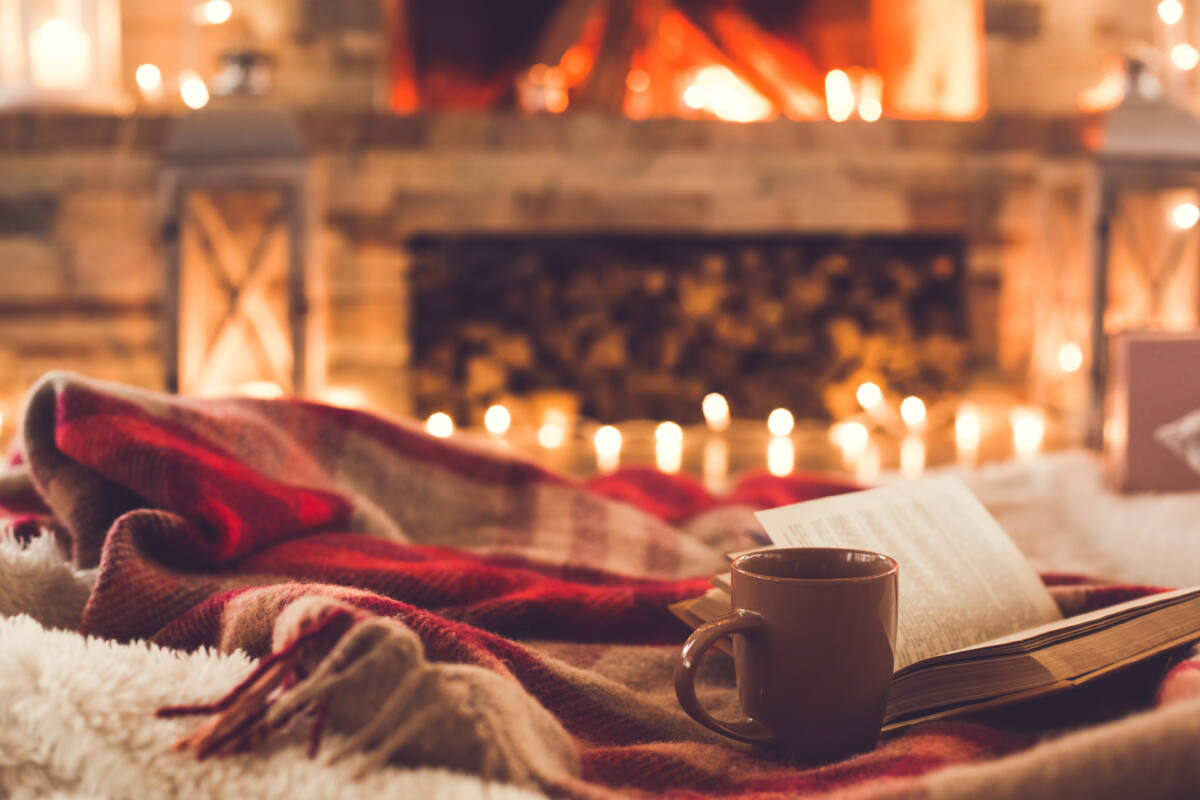 One cup of cocoa and a book near the fireplace christmas leisure
