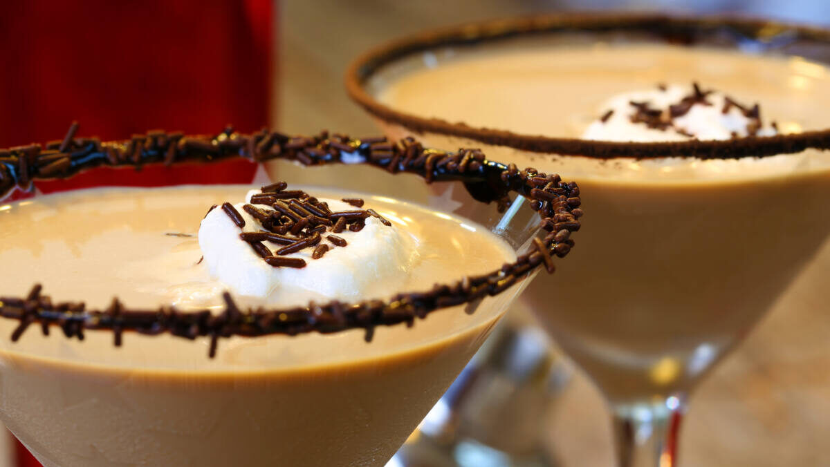 Chocolate martinis garnished in chocolate sprinkles and whipped cream