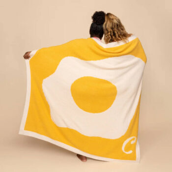 Yellow blanket with sunny side egg on it