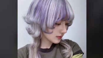 woman with jellyfish haircut on purple hair