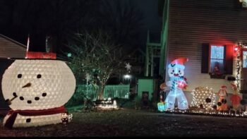 jughead the snowman in yard with other lights by house