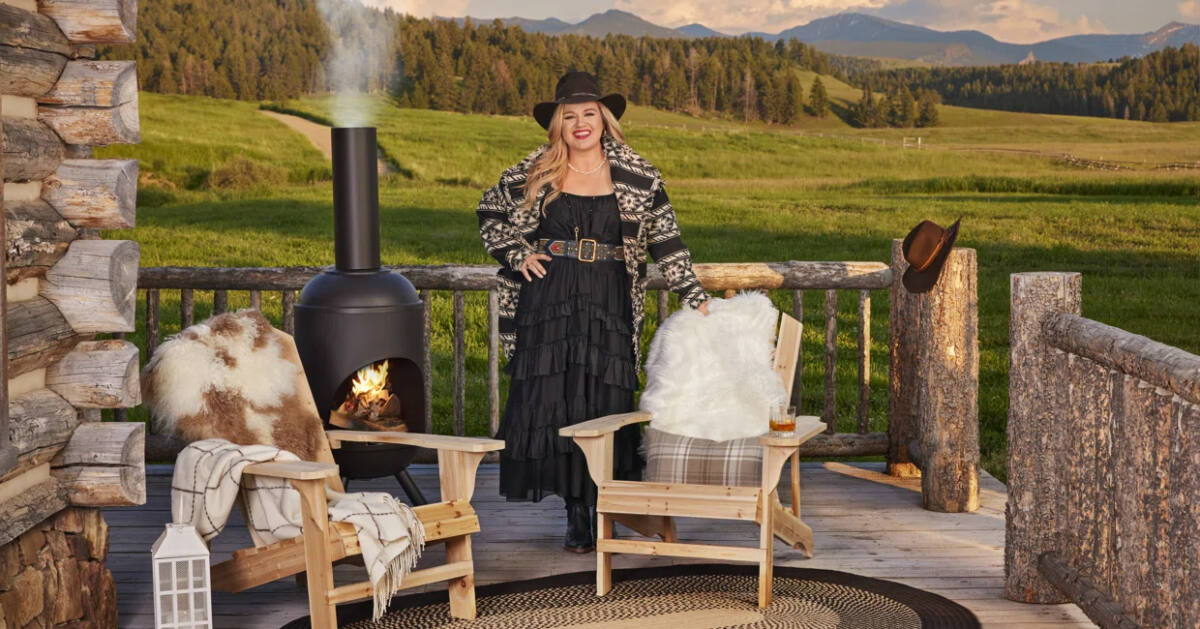 Kelly Clarkson stands on outdoor Montana deck with some of her home line