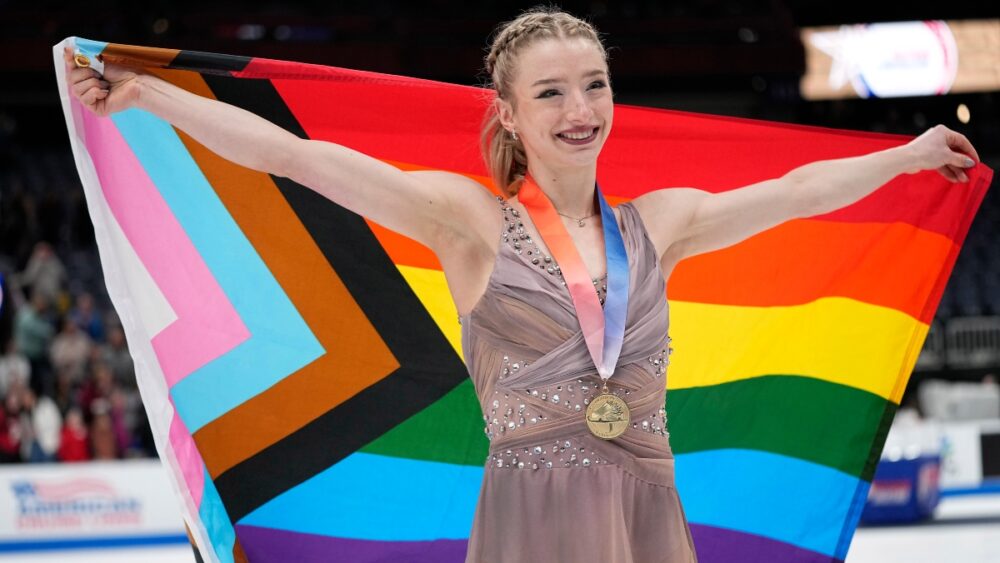 Amber Glenn poses with LGBTQ+ flag