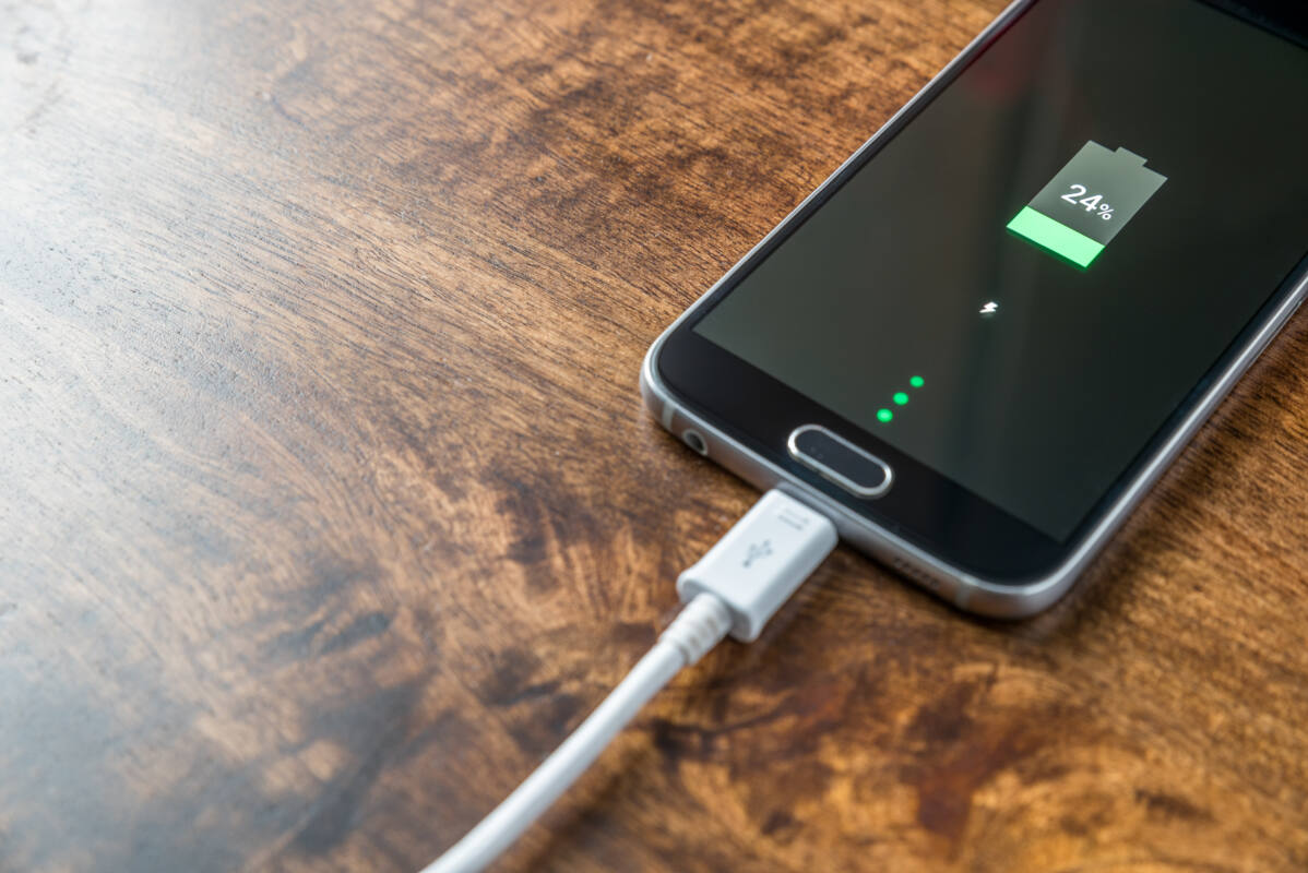 Smartphone battery plugged in and charging at 24 percent