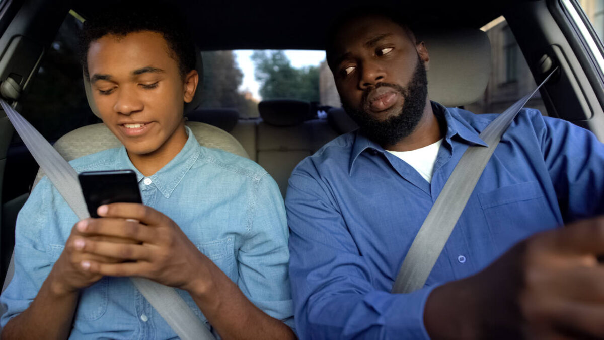 Dad, driving, glances suspiciously at teen texting