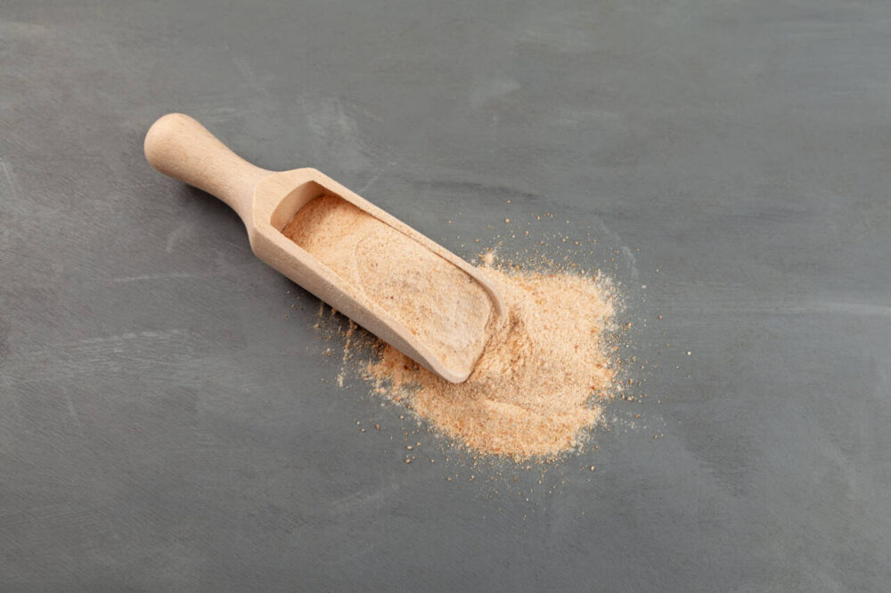 Date sugar in wooden scoop