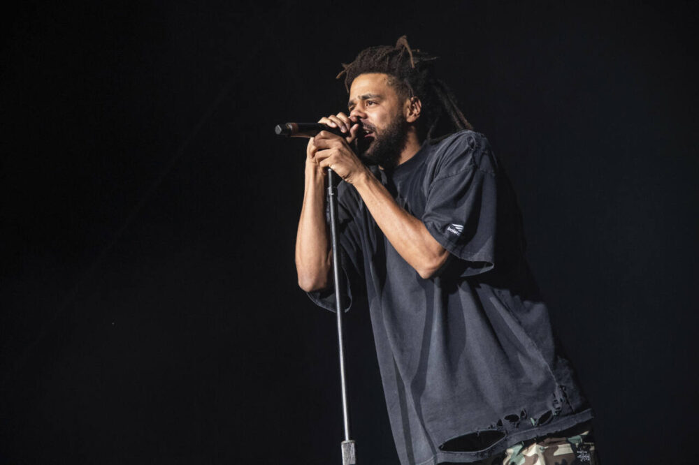 Rapper J. Cole performs at microphone