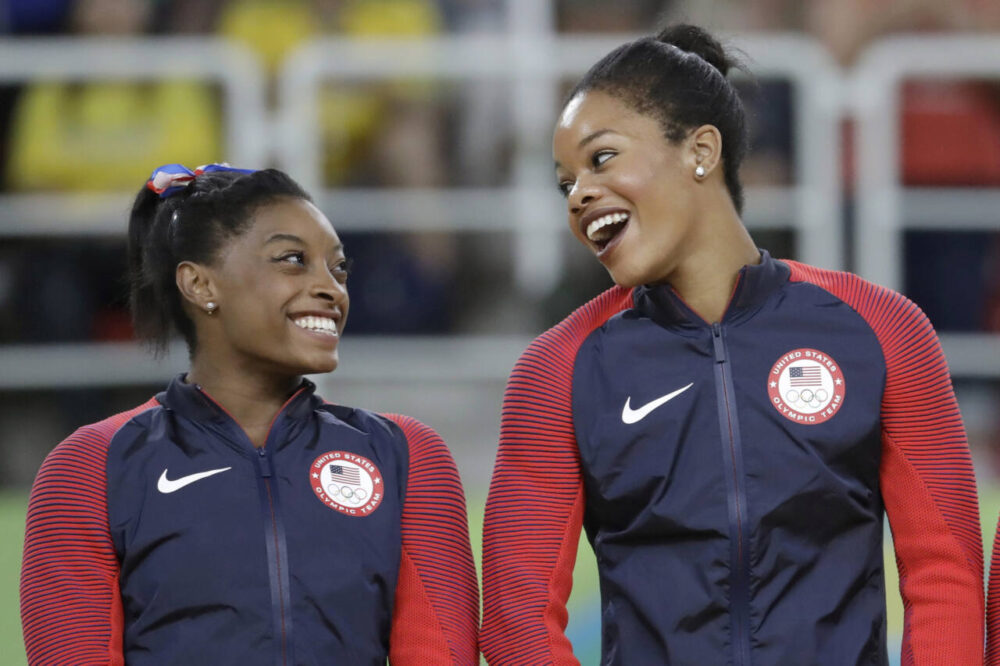 Simone Biles and Gabby Douglas on podium at competition in 2016