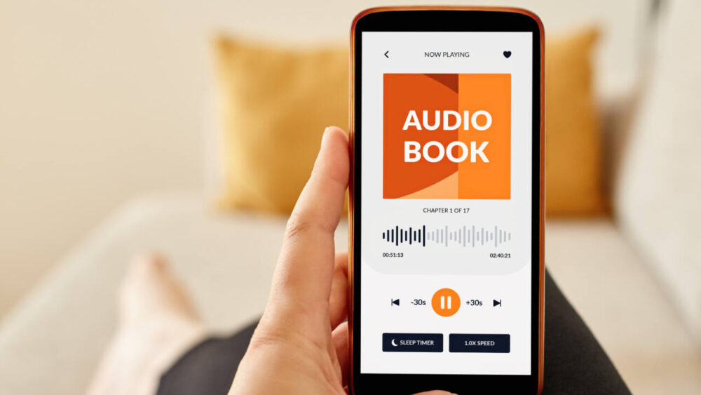 A person listens to an audiobook on their phone.