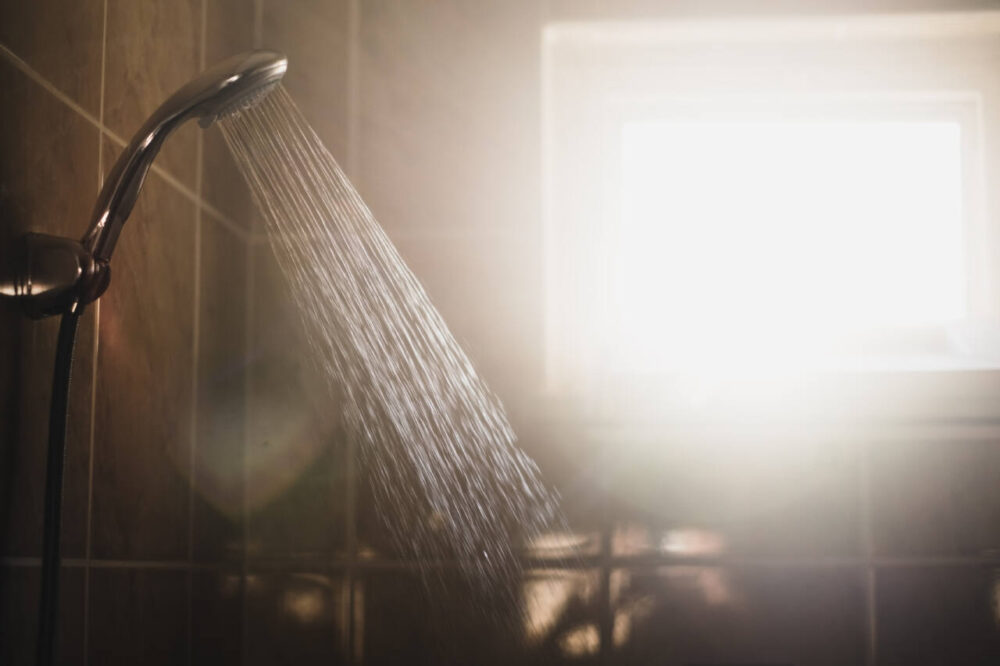 shower with flowing water and steam