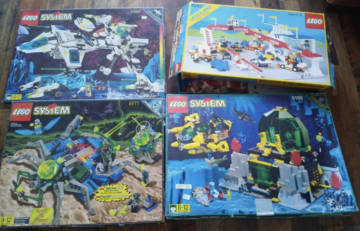 four Lego sets in boxes