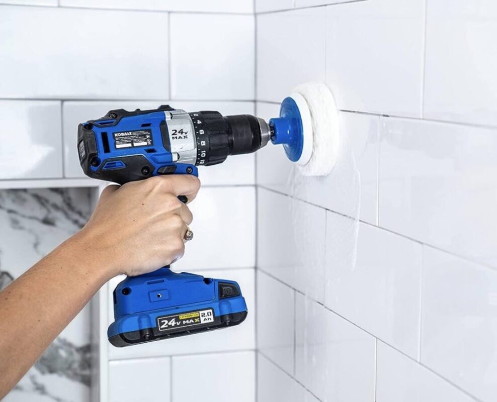 shower scrubber being used on tile walls