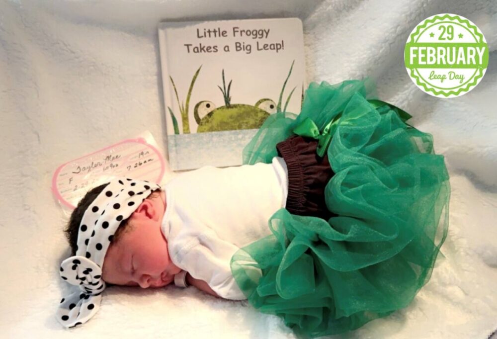 Newborn baby in green tutu