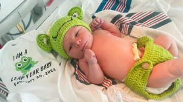 Baby born on leap day with cute frog outfit