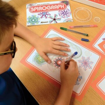 Child playing with Spirograph toy