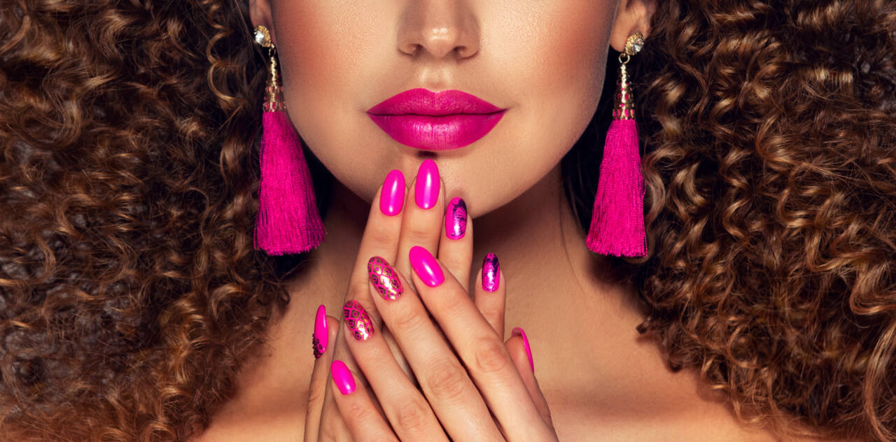 A woman wears bright fuchsia lipstick.