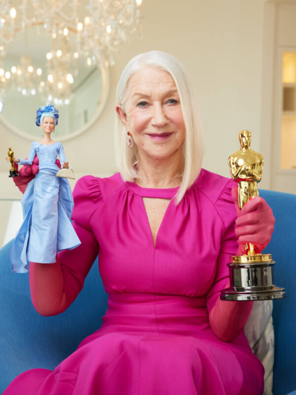 Helen Mirren with her Barbie and an Oscar award