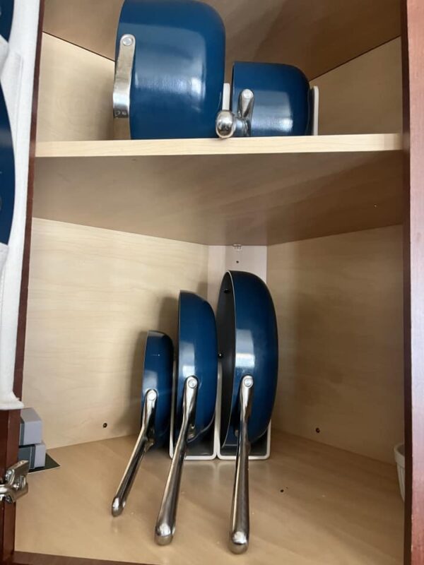 My Caraway Cookware set stored in a cabinet.